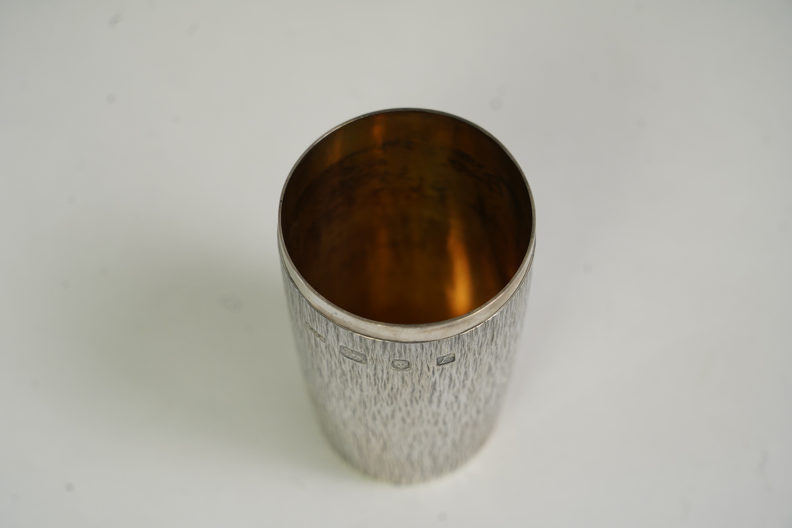 An Elizabeth II bark effect textured silver beaker by Adrian Gerald Benney